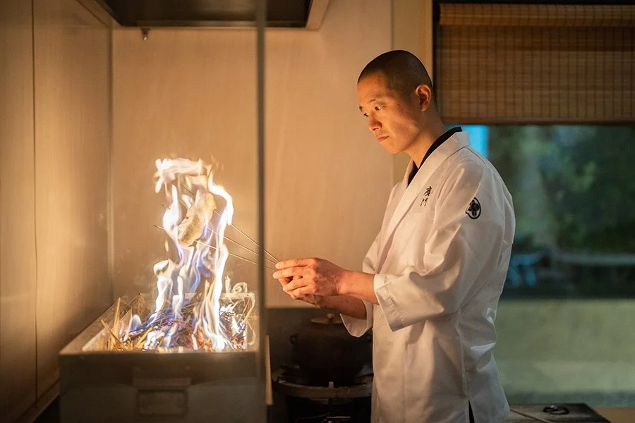 料理人が炉端で調理する様子