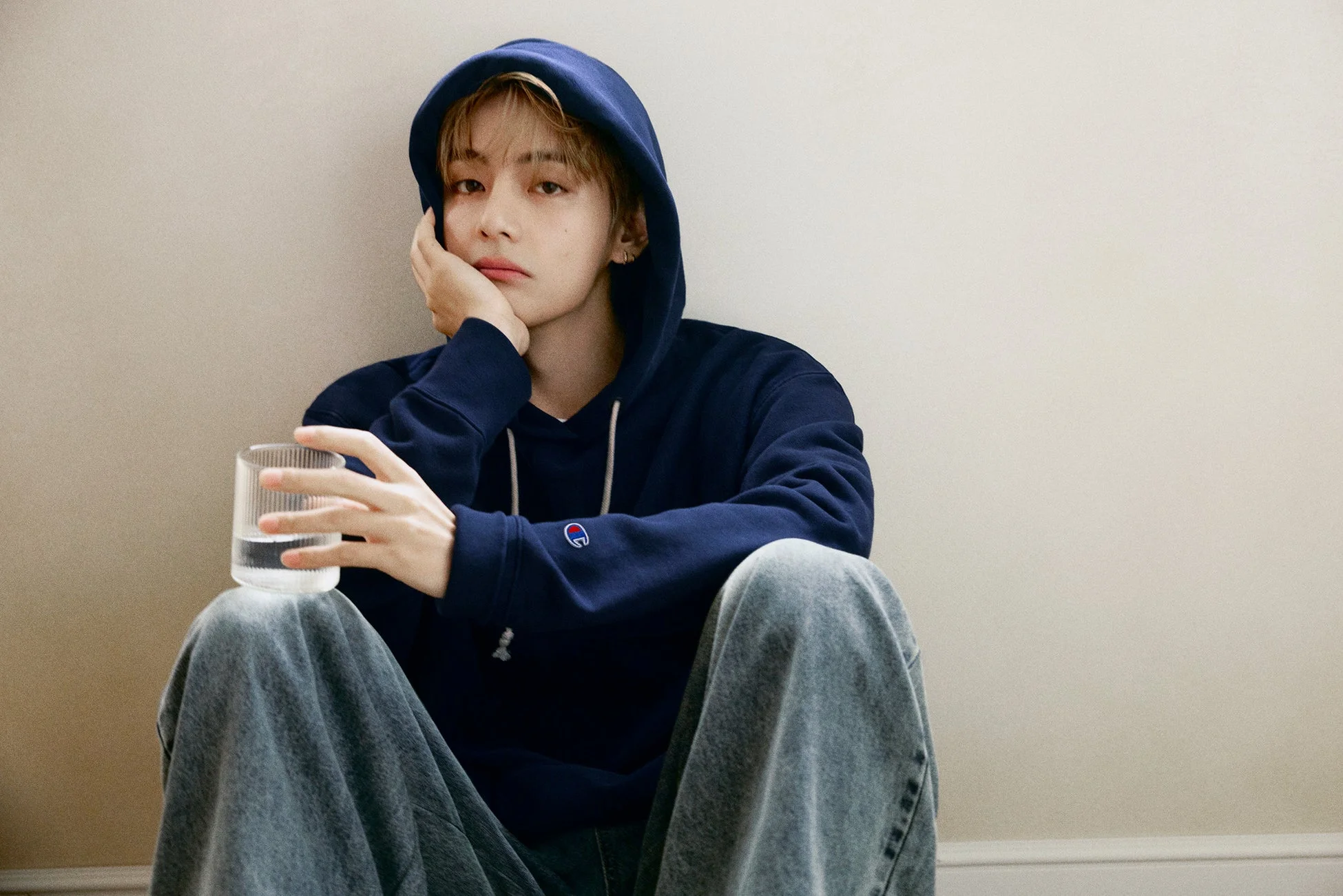 V in navy hoodie