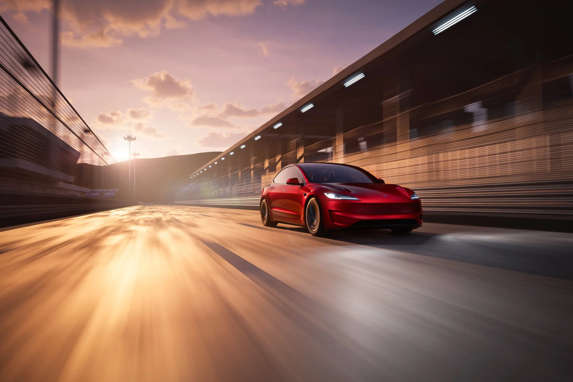 夕焼けのサーキットを走る赤いテスラ Model 3