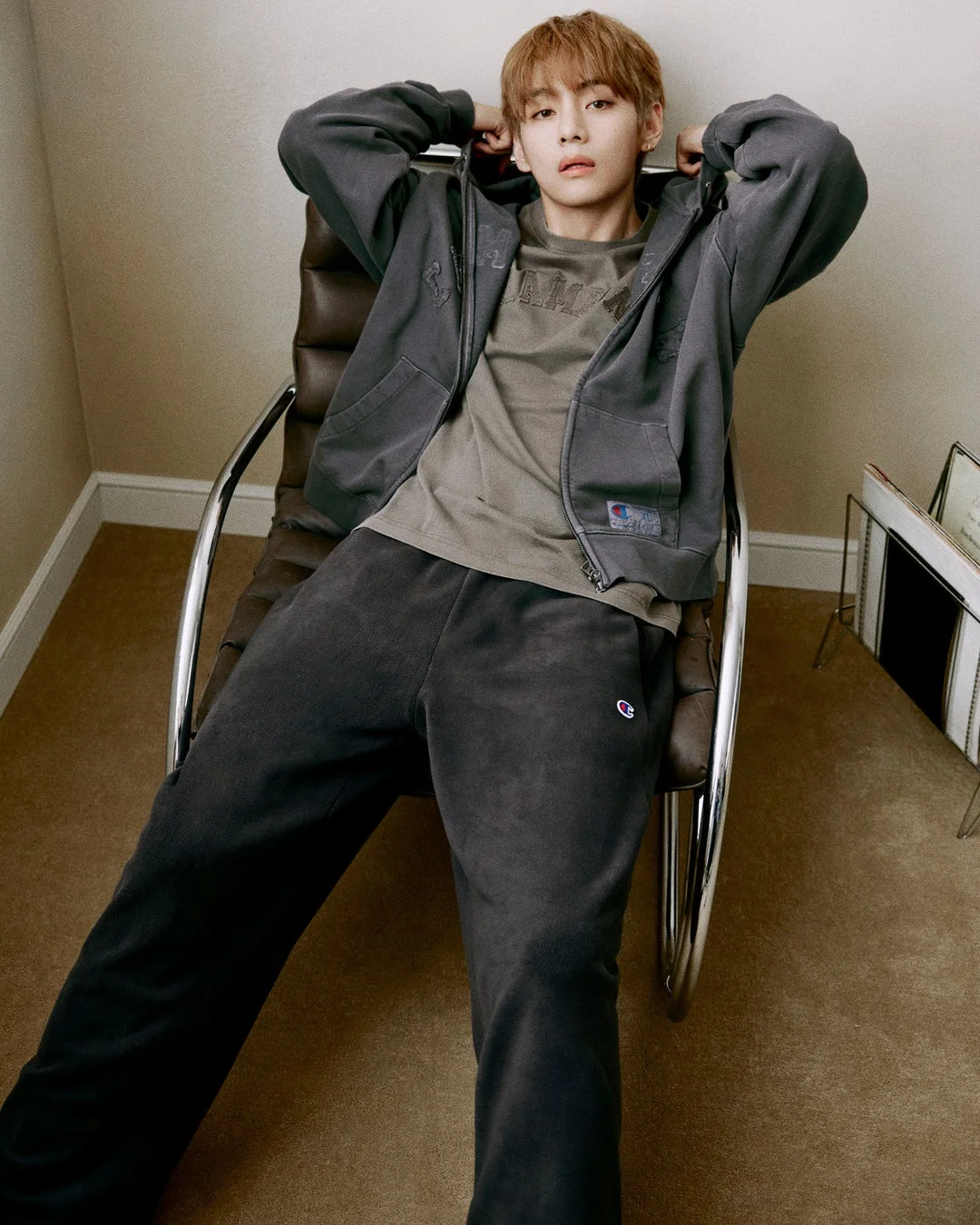 V in grey hoodie sitting