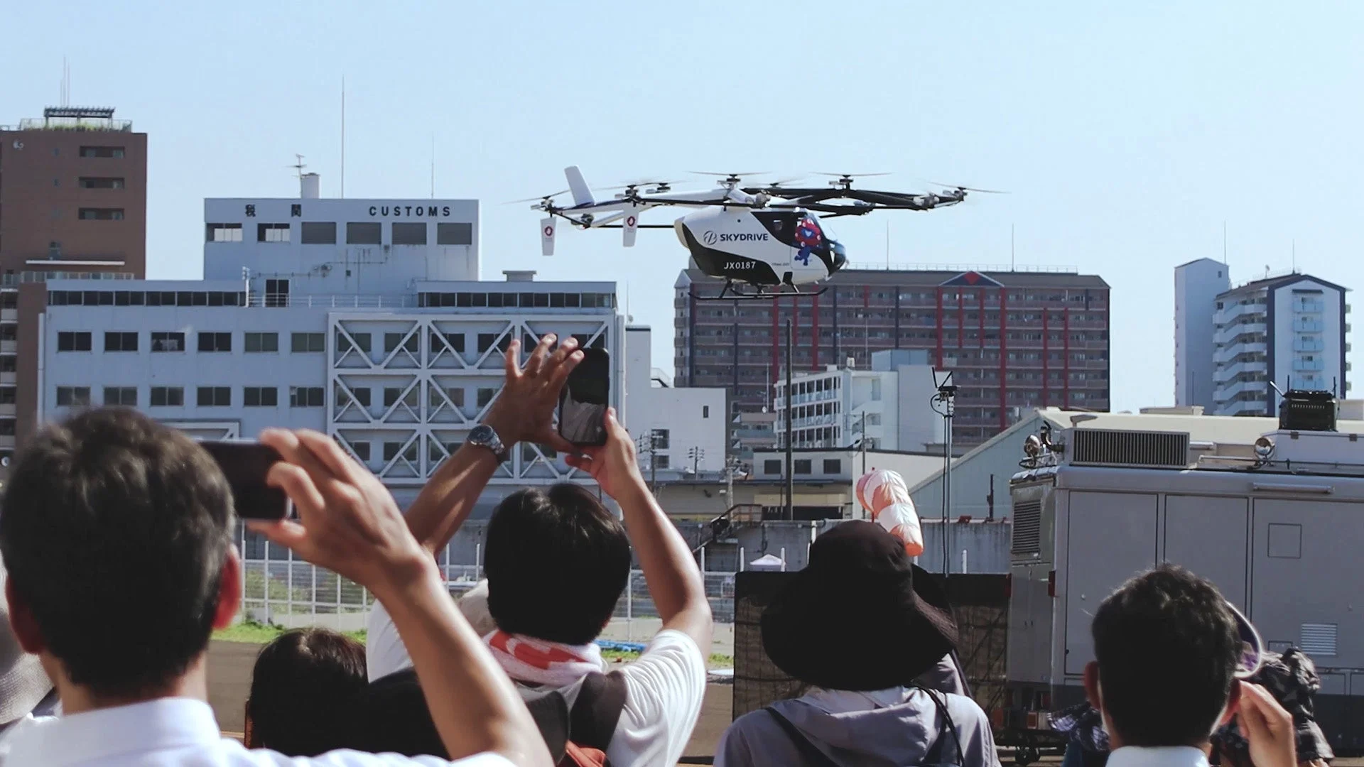 空飛ぶクルマのデモンストレーションを見守る人々