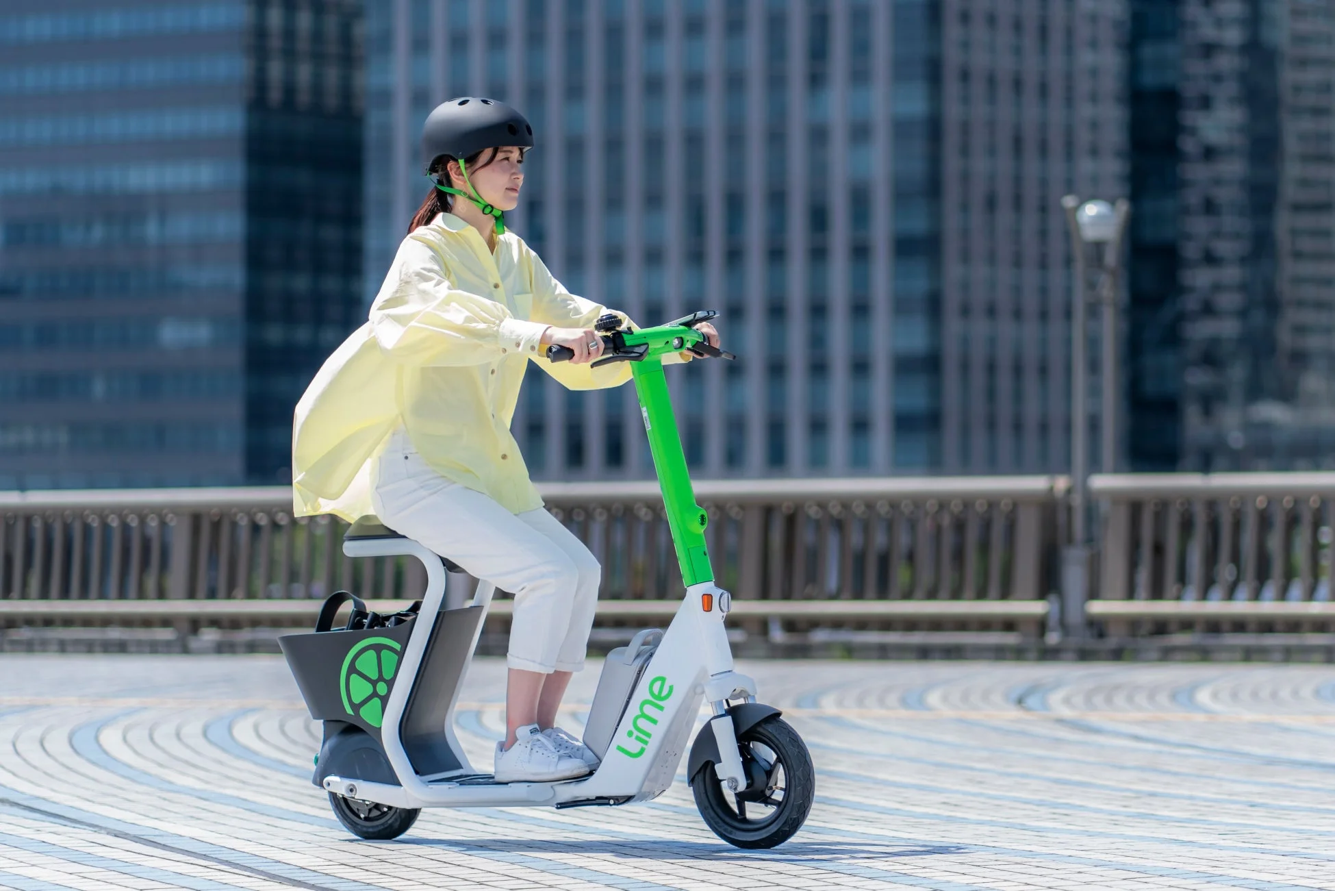 都市で電動キックボードに乗る女性